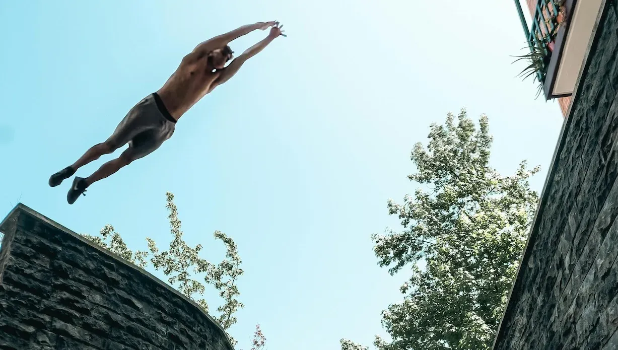 Parkour athlete superman flying over obstacles